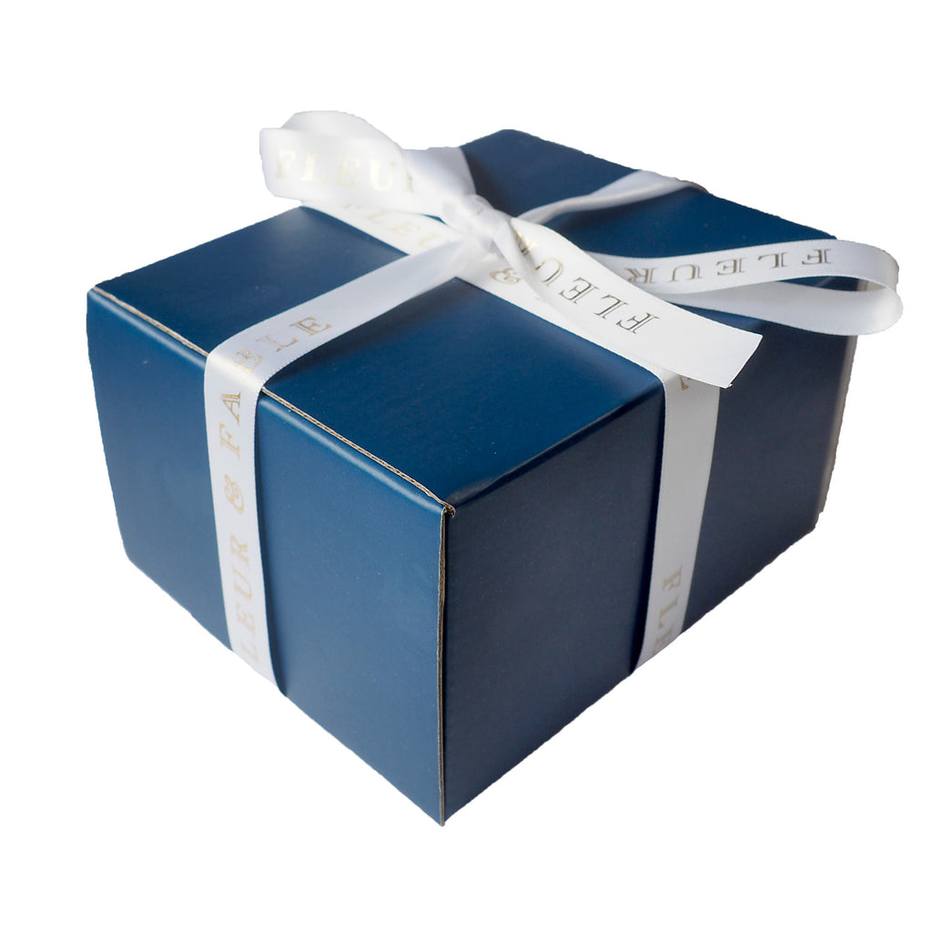 blue gift box with white and gold ribbon