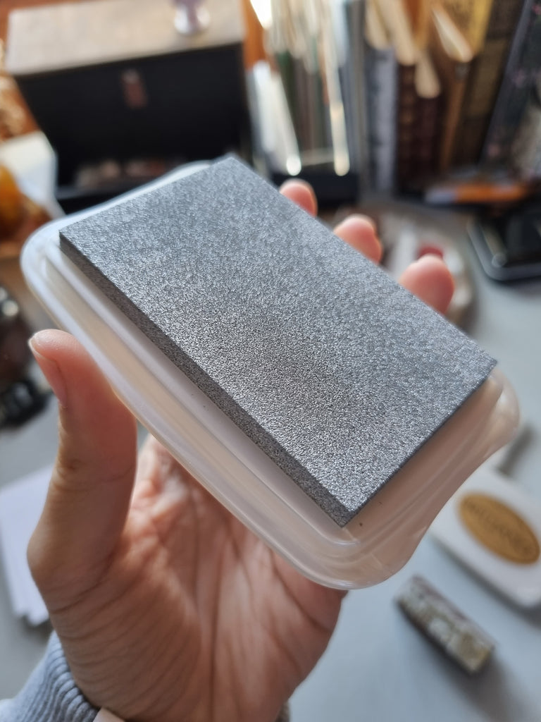 Open silver ink pad showing raised surface