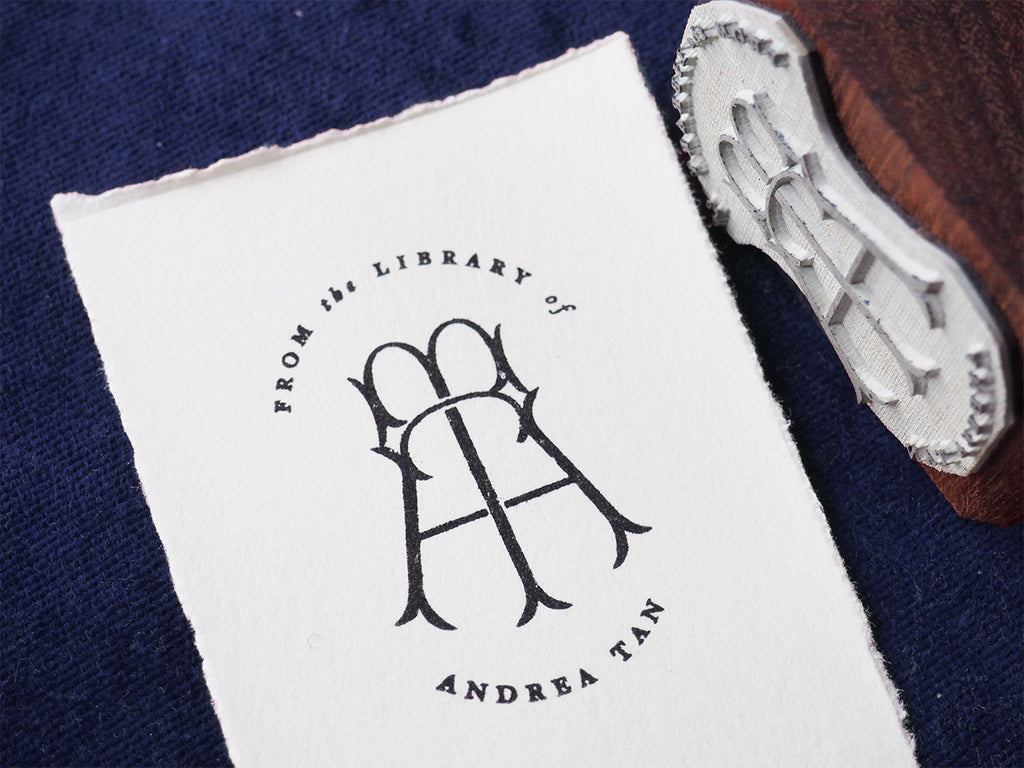 'From the library of...' traditional rubber stamp bookplate on paper