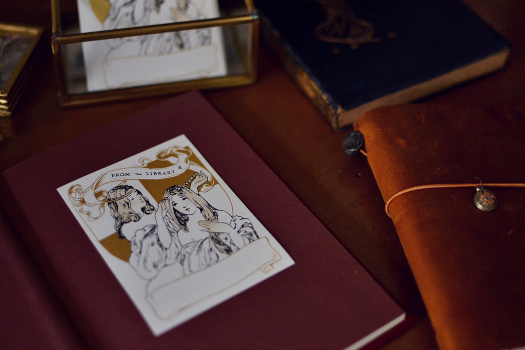 Close up of Star Light & Star Bright bookplate sticker stuck in book on a desk