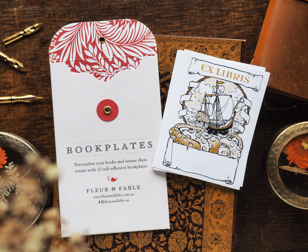 Bookplate packaging and Crossing the Seas bookplate stickers flatlay on a desk