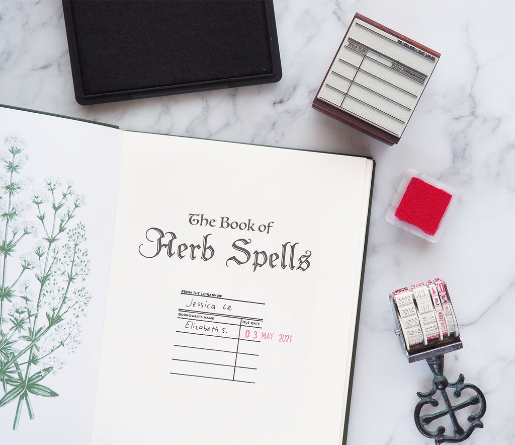 From the library of stamp with date stamp, ink pad and open book