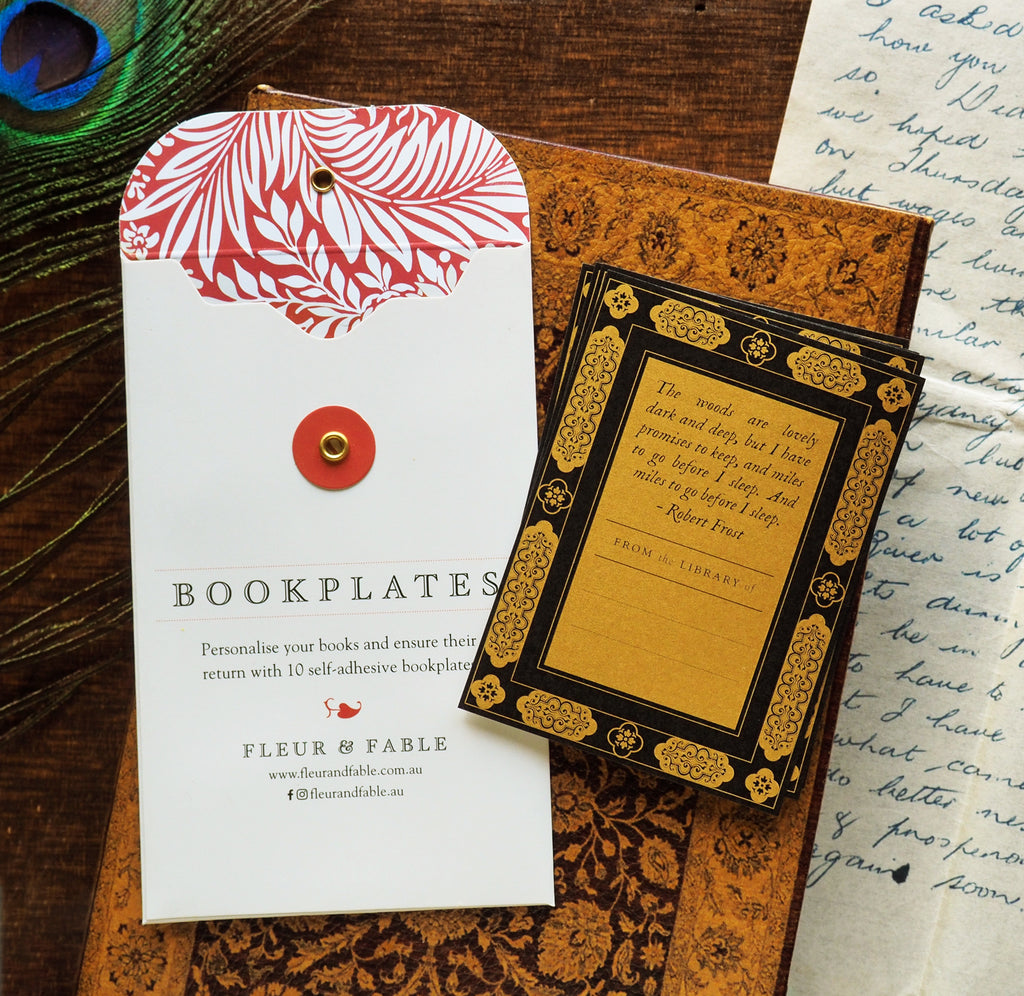 Bookplate packaging and One Thousand Nights bookplate stickers flatlay on a desk