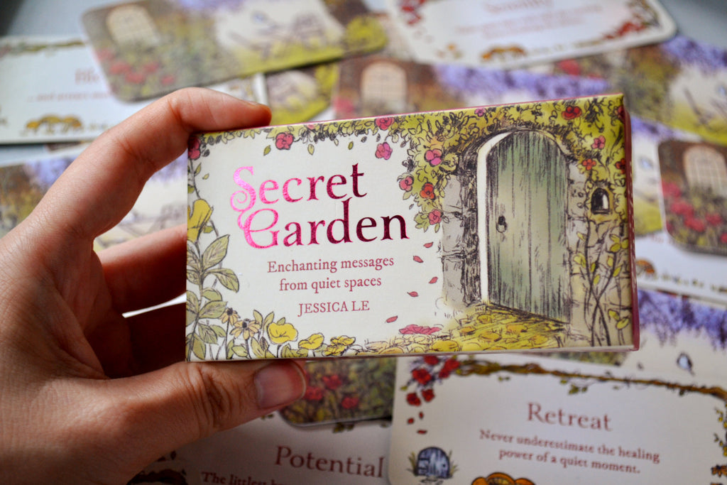 Hand holding Secret Garden Mini Inspiration Cards box packaging showing dark pink text foiling