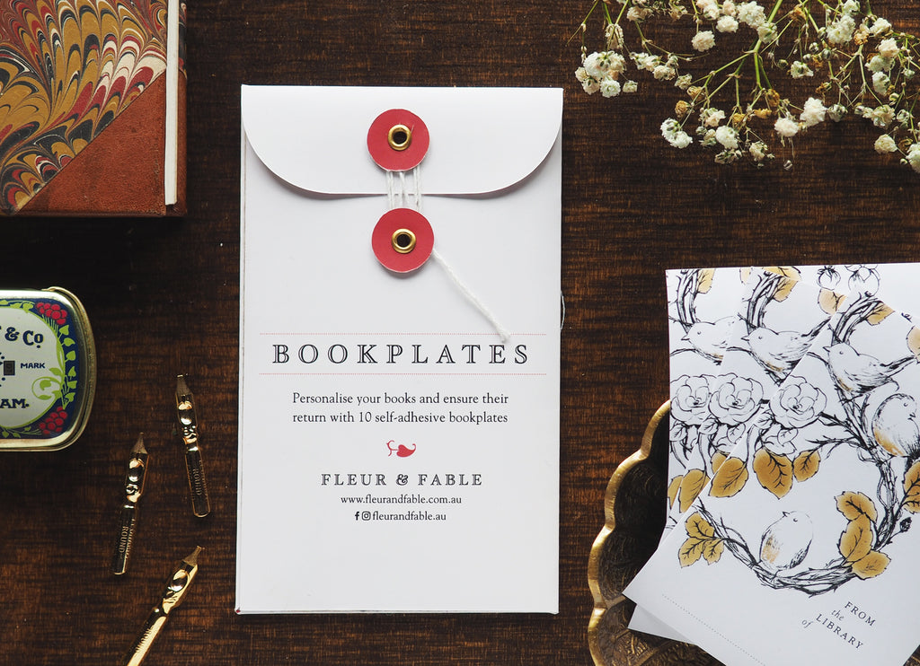Bookplate packaging and bird bookplate stickers flatlay on a desk
