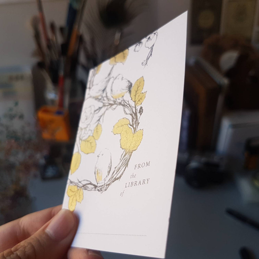 Bird bookplates from the side showing gold ink