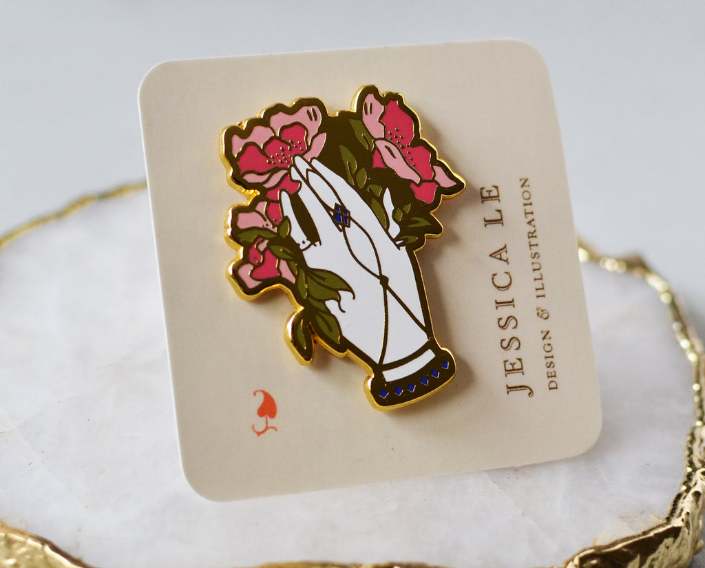 Victorian floral hand enamel pin secured to backing card